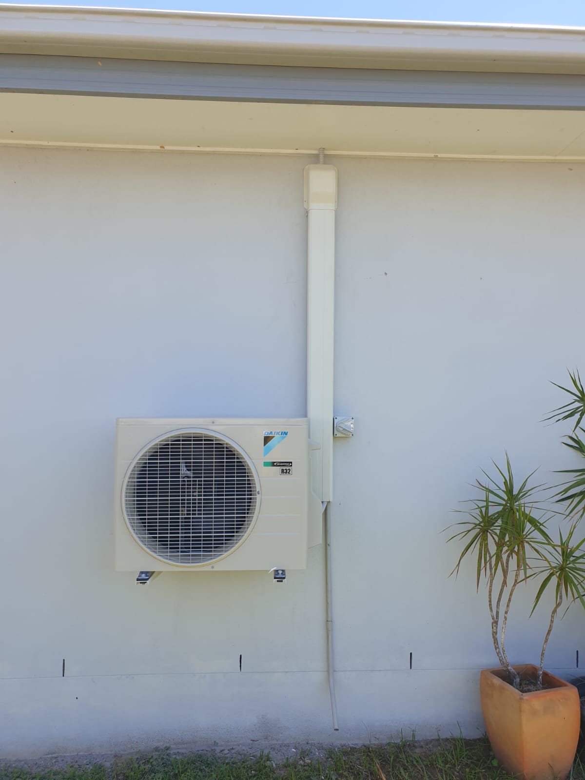 Daikin outdoor condenser unit installed on house