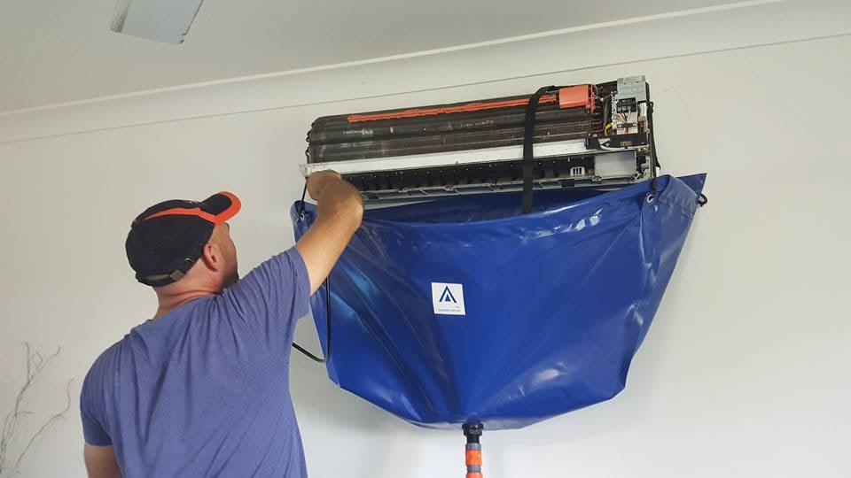 Technician performing AC deep clean service
